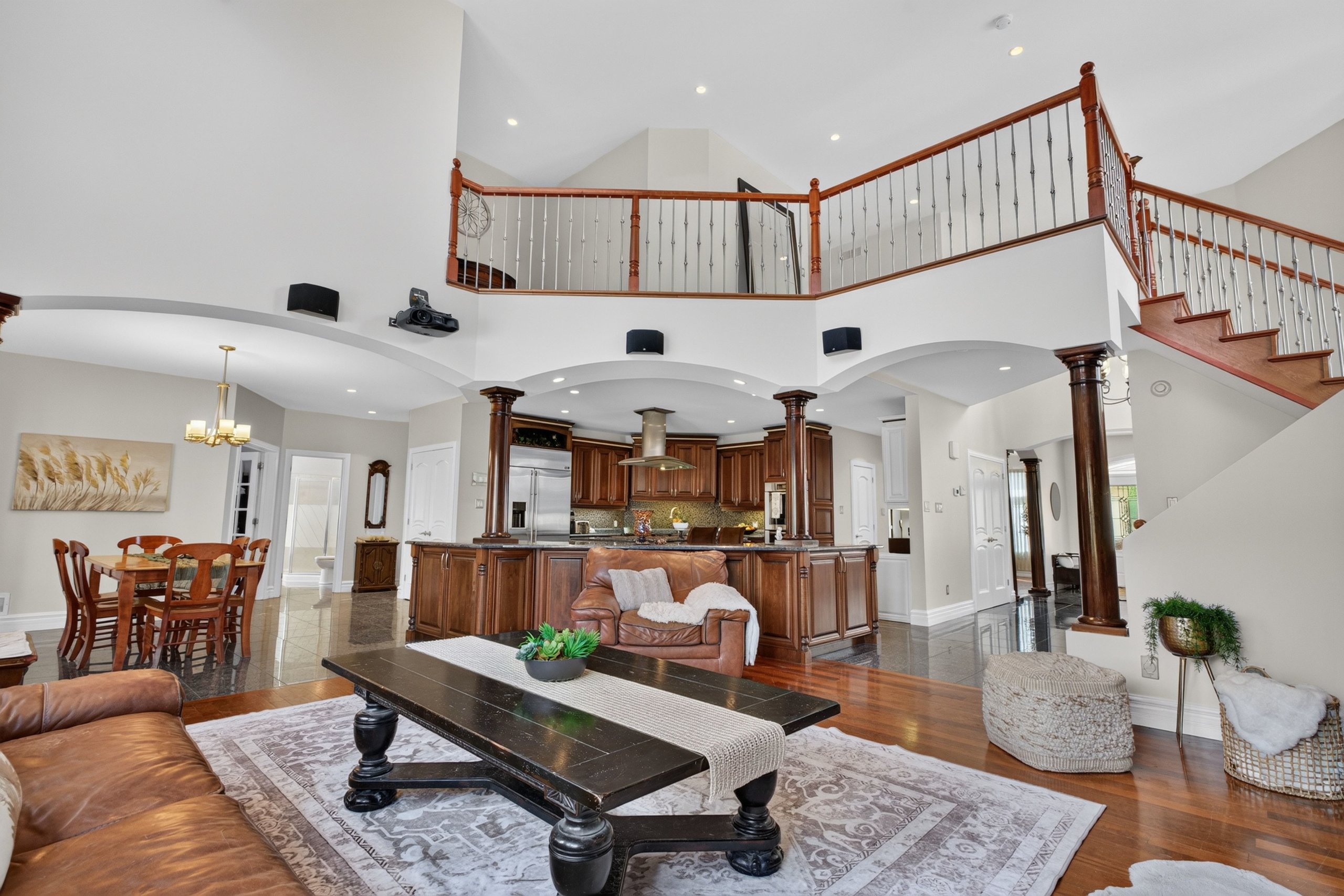 Great room open to the second floor with kitchen beyond